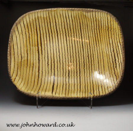 A large size English earthenware combed decorated slipware baking dish or loaf dish circa 1800.