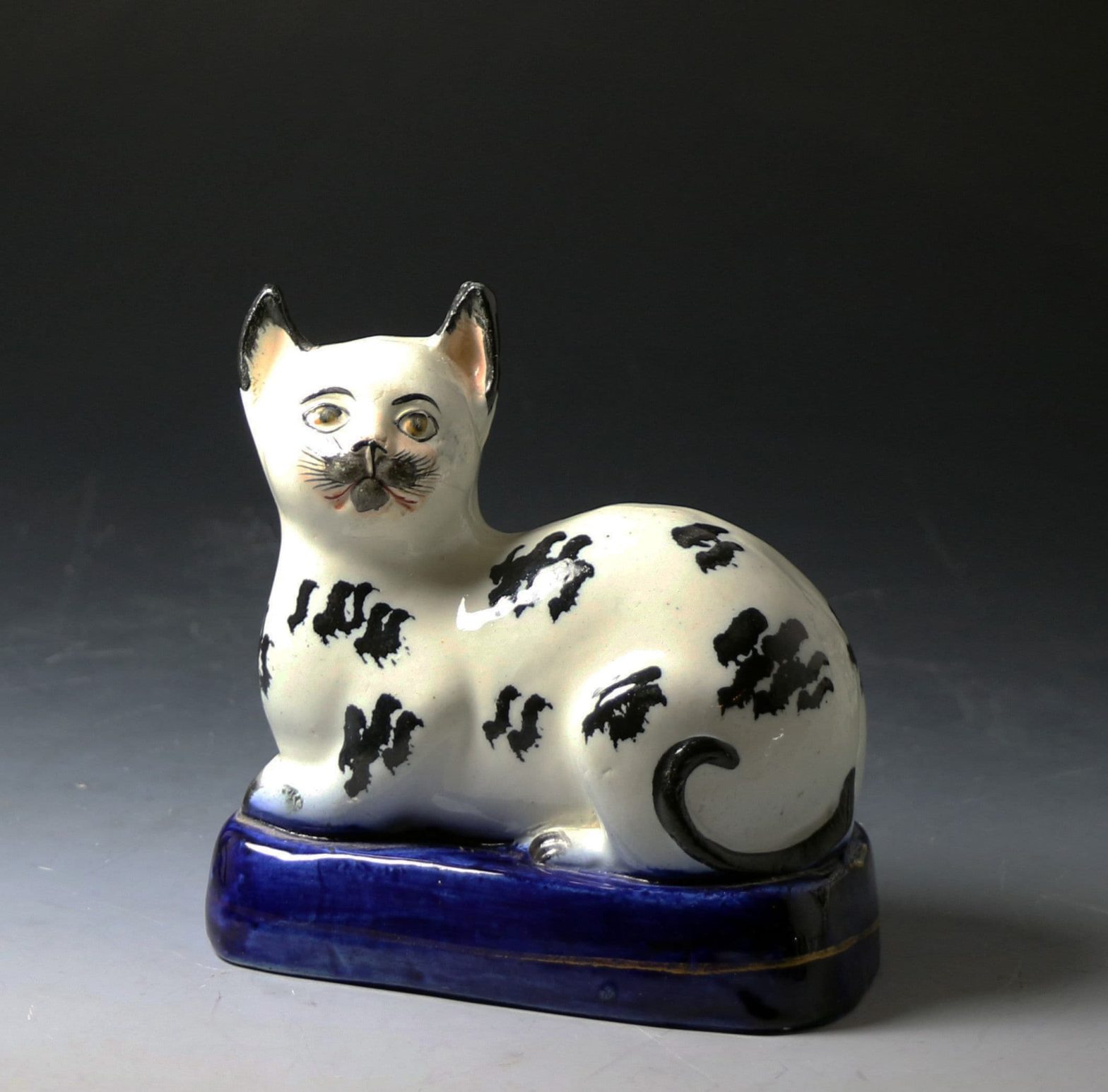 Antique Staffordshire pottery figure of a black and white cat mid 19thc