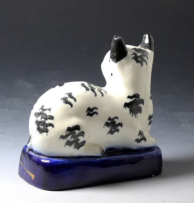 Antique Staffordshire pottery figure of a black and white cat mid 19thc