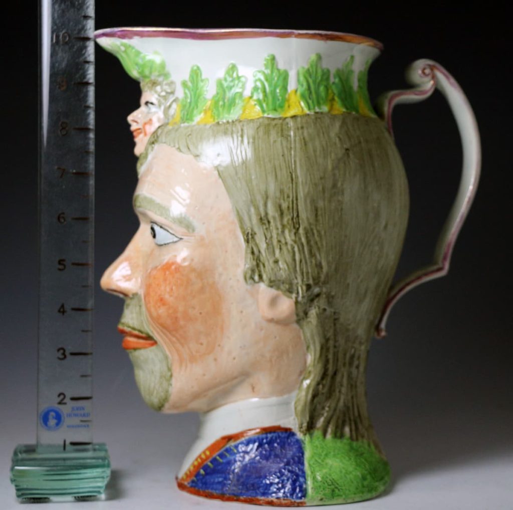 Staffordshire pottery pitcher in the form of male head with mask face