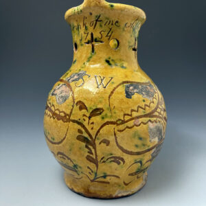 Early Donyatt Pottery slipware pottery puzzle jug inscribed with date 1754 and a verse.