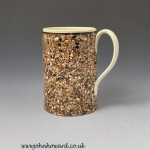 Surface decorated agateware tankard with creamware body English late 18th century