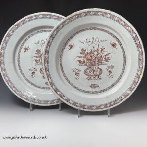 Pair of large English delftware dishes with quill application in red and blue c1740