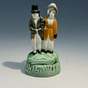 Yorkshire Pottery Prattware diminutive figure of a couple standing on a green base. c1810