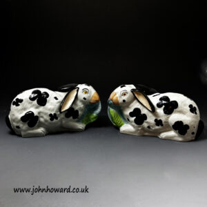 Staffordshire pottery crouching rabbits nibbling leaves mid 19th century England